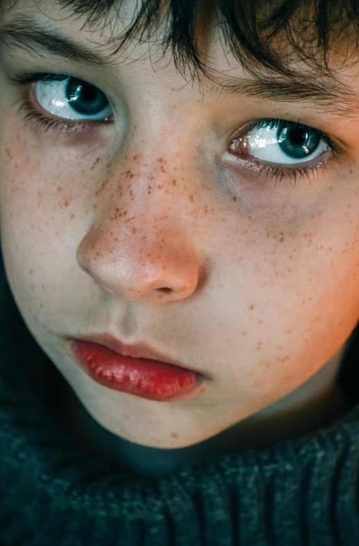 a close up of a child with freckles on his face, pexels contest winner, hyperrealistic teen, stars in her gazing eyes, lights on, surface blemishes