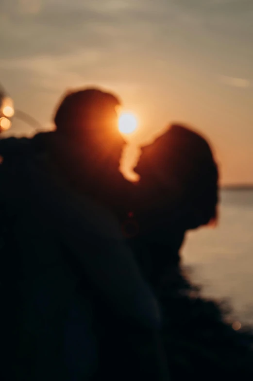 a man and a woman kissing in front of the sun, pexels, blurred, cinematic movie still, shot on sony a 7, ✨🕌🌙