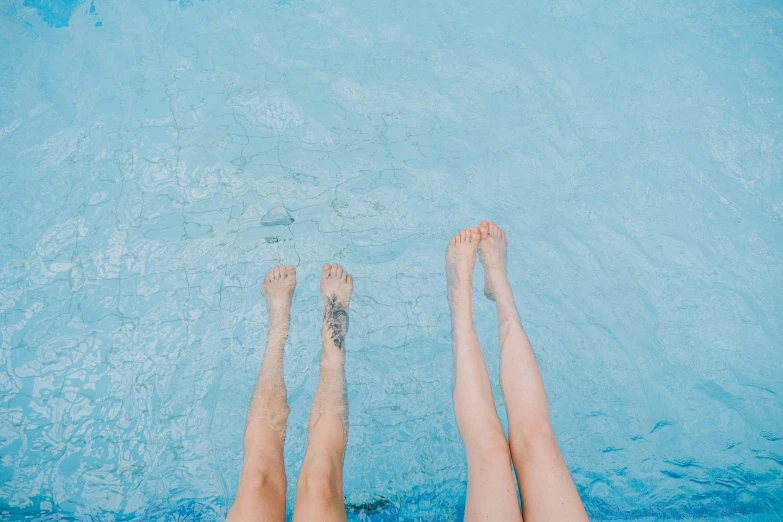 two legs in the water of a swimming pool, by Elsa Bleda, pexels contest winner, aestheticism, lesbians, light blue skin, plain background, 15081959 21121991 01012000 4k