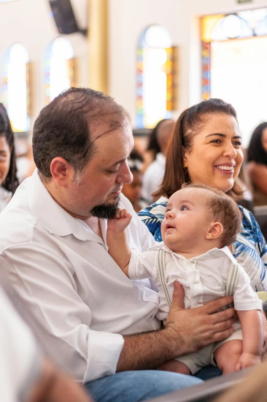 a group of people sitting in a church together, incoherents, father with child, in sao paulo, baptism, profile image