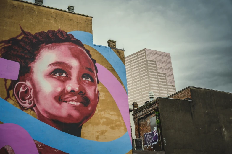 a mural of a woman on the side of a building, by artist, pexels contest winner, light skinned african young girl, new orleans, 144x144 canvas, panoramic view of girl