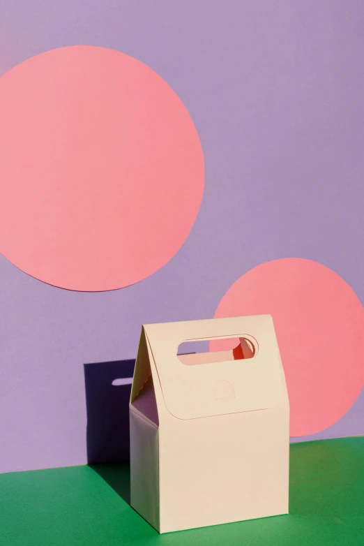 a white box sitting on top of a green table, by Eden Box, color field, bags, in a shapes background, minimal pink palette, promo image