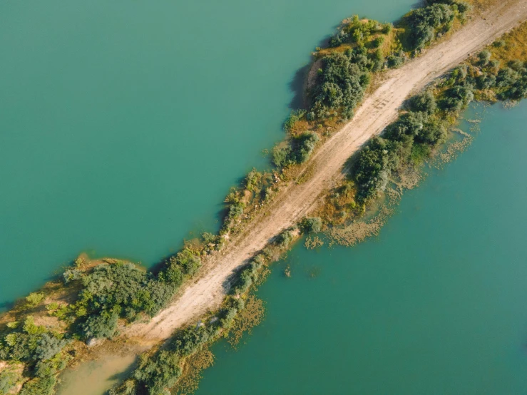 an aerial view of a dirt road next to a body of water, pexels contest winner, floating island, beautiful composition 3 - d 4 k, no words 4 k, portrait photo