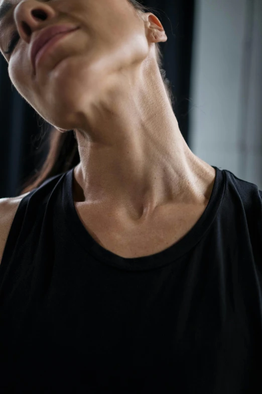 a woman holding a cell phone up to her ear, by Nina Hamnett, hyperrealism, muscular neck, in a gym, neck zoomed in, alessio albi