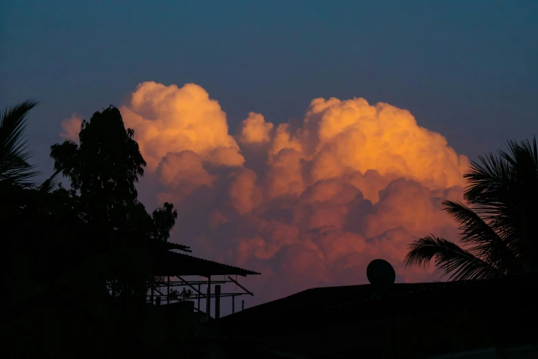 a large cloud that is in the sky, pexels contest winner, romanticism, sunset lighting ominous shadows, tropical climate, orange / pink sky, instagram post