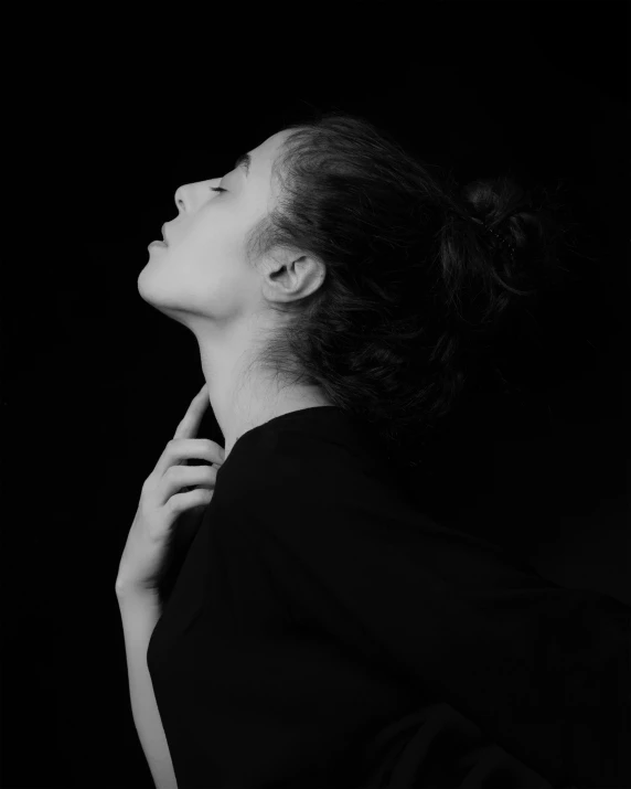 a black and white photo of a woman, inspired by irakli nadar, unsplash contest winner, focused on her neck, praying posture, album cover, profile posing