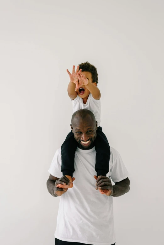 a man holding a child on his shoulders, inspired by Paul Georges, pexels contest winner, virgil abloh, pose(arms up + happy), profile image, full head and shoulders