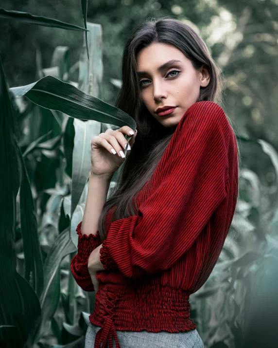 a woman in a red sweater standing in a corn field, inspired by Elsa Bleda, trending on pexels, renaissance, angela sarafyan, portrait image, foliage clothing, dark red