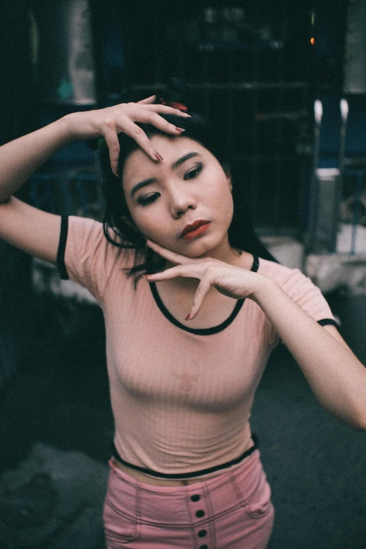 a woman in a pink shirt posing for a picture, an album cover, inspired by Elsa Bleda, pexels contest winner, realism, asian girl, croptop, concerned, cynthwave