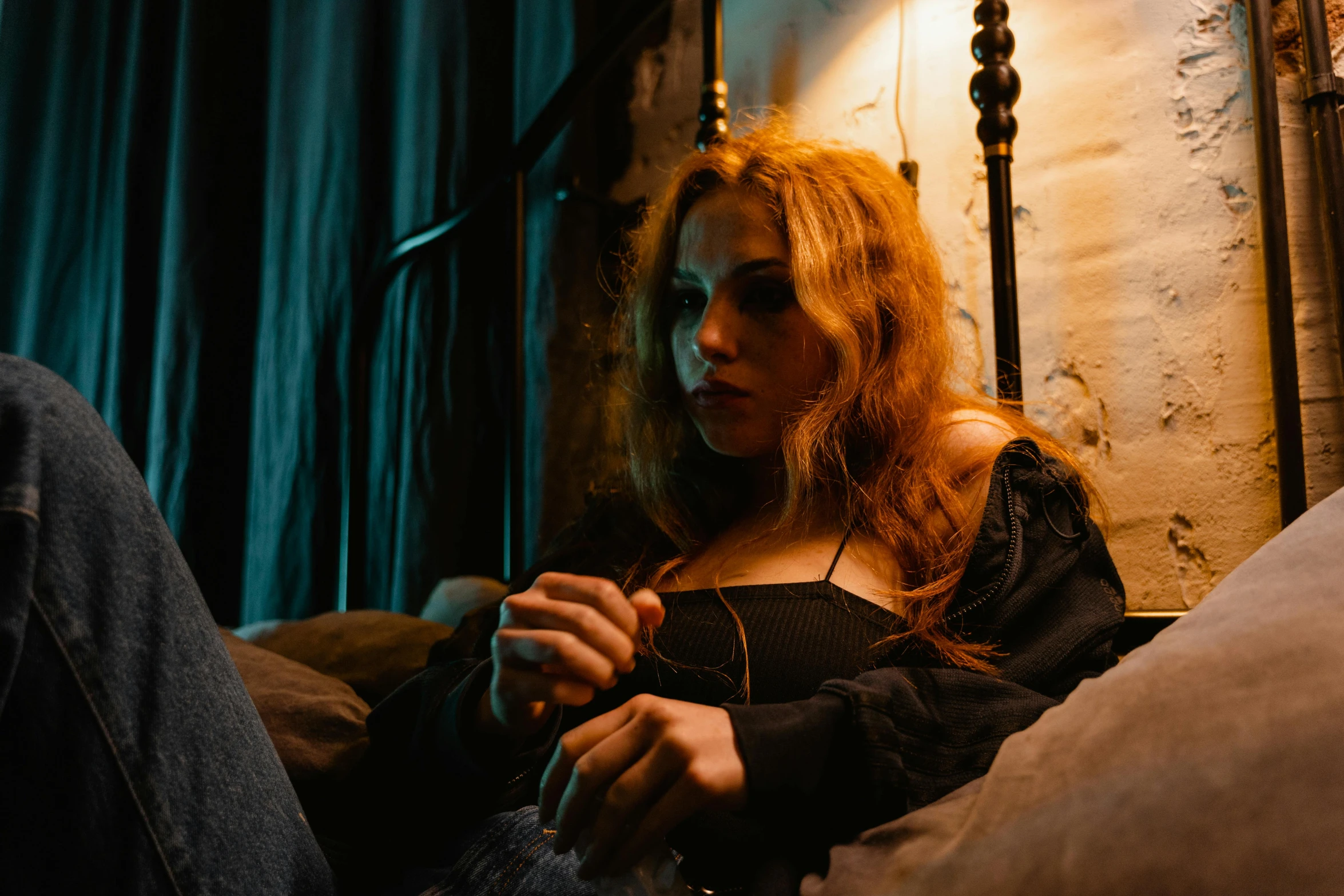 a woman sitting on a bed with a remote in her hand, inspired by Elsa Bleda, trending on pexels, renaissance, redhead female cyberpunk, sitting alone at a bar, scarlet johansen, sydney sweeney