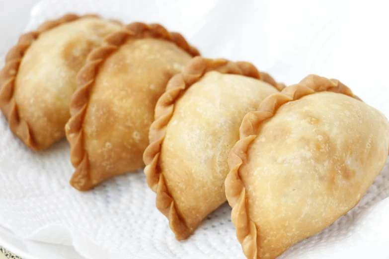 a close up of three pastries on a plate, south east asian with round face, fan favorite, 3/4 front view, fanoos