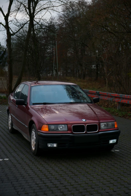 a red car is parked on the side of the road, around 1 9 years old, bmw, vhsrip, portrait shot 8 k