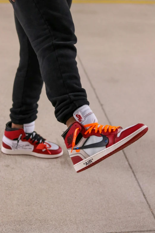 a close up of a person's shoes on a skateboard, inspired by Jordan Grimmer, trending on dribble, red and orange colored, off - white collection, “air jordan 1, standing on 2 feet
