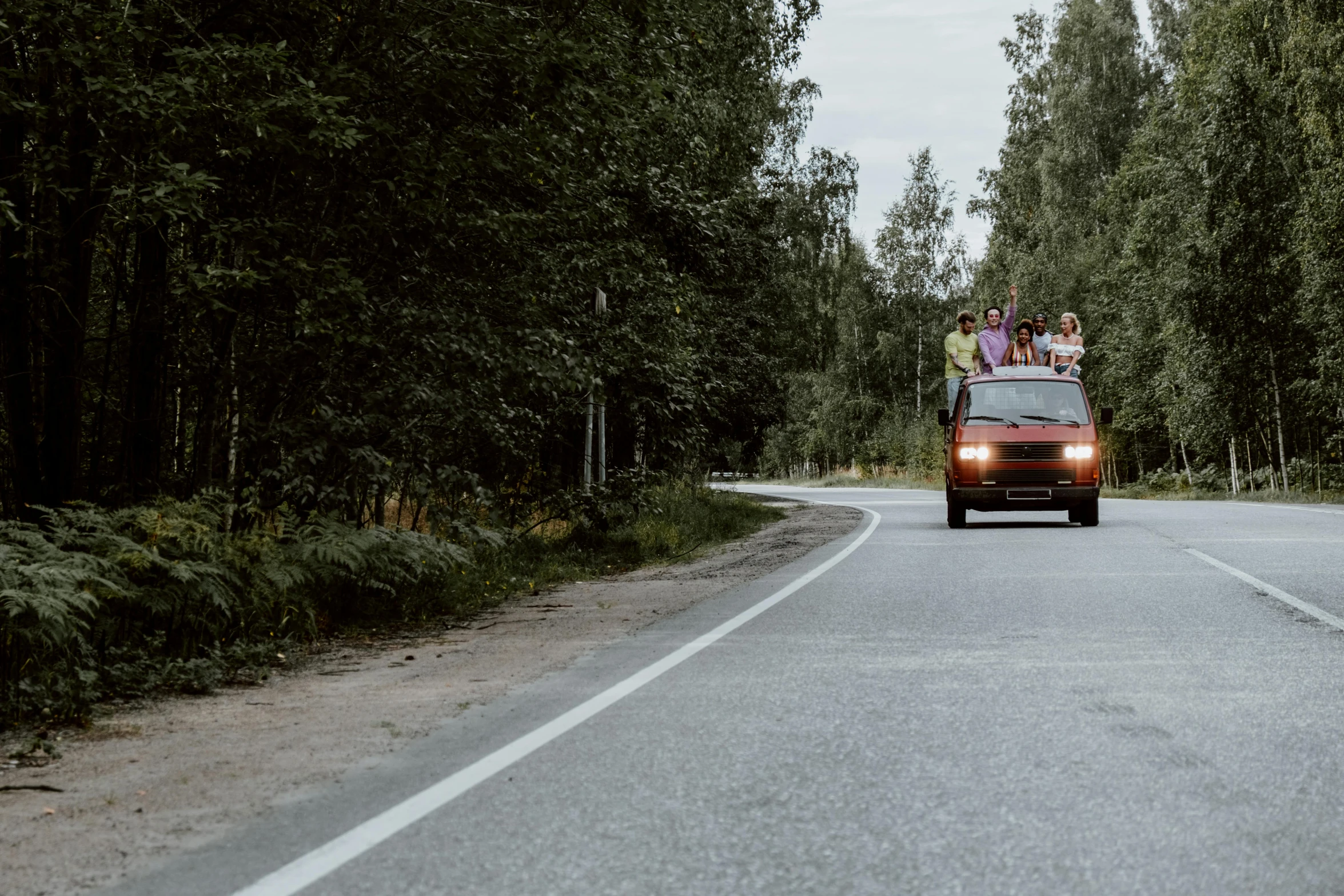 a group of people riding in the back of a van down a road, by Jaakko Mattila, pexels contest winner, hurufiyya, midsummer, lada car, thumbnail, high resolution image