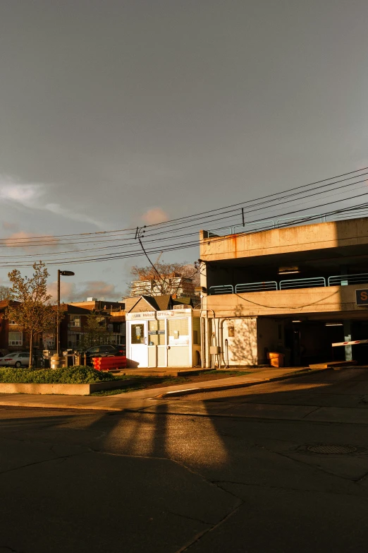 a red fire hydrant sitting on the side of a road, an album cover, inspired by Washington Allston, photorealism, panoramic anamorphic, sun down, brutalism buildings, taken with sony alpha 9