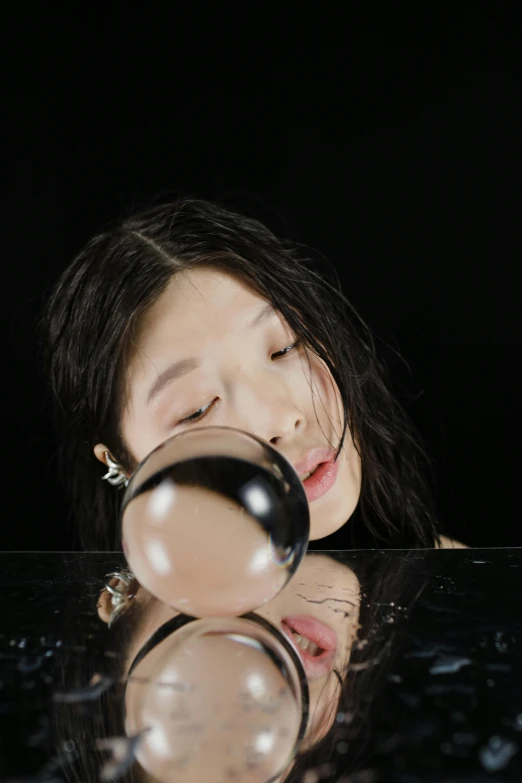 a woman looking through a magnifying glass, an album cover, inspired by Fei Danxu, trending on pexels, hyperrealism, water bubble, bae suzy, studio portrait, floating drowned