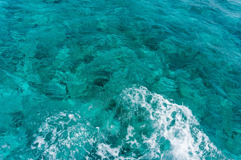 a view of the ocean from the top of a boat, by Robbie Trevino, pexels, hurufiyya, carribean turquoise water, super clear detailed, lots of swirling, sea floor