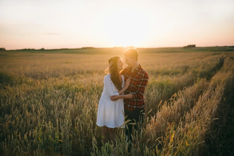 a couple standing in a field at sunset, pexels contest winner, attractive girl, romantic lead, plain background, uploaded