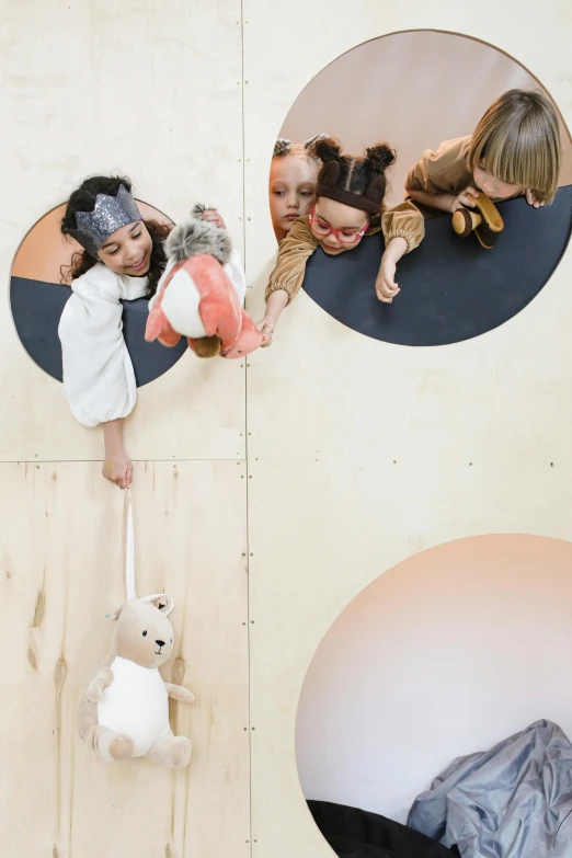 a group of children playing with stuffed animals, inspired by Isamu Noguchi, trending on unsplash, interactive art, portholes, dwell, aerial spaces, dezeen showroom