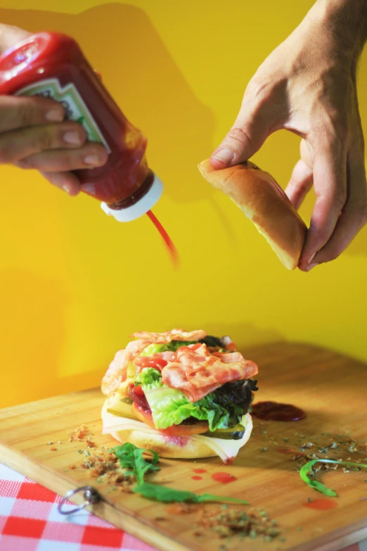 a person putting ketchup on a sandwich, a picture, pexels contest winner, vibrant aesthetic, pouring, no - text no - logo, bao phan