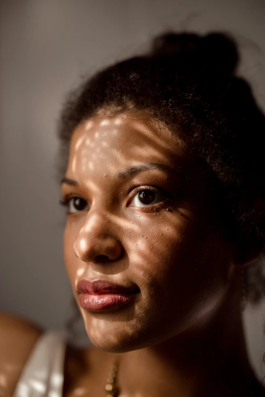 a close up of a woman with dirt on her face, inspired by Gordon Parks, diffuse natural sun lights, under a spotlight, brown skinned, full sun