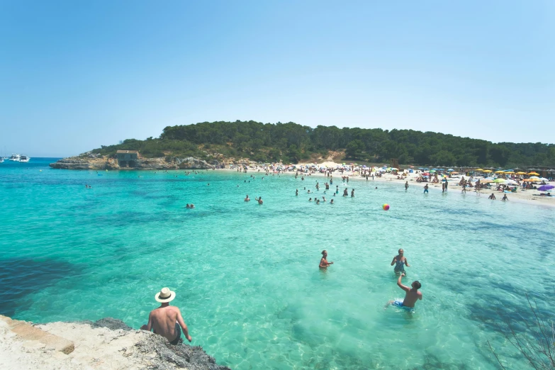 a group of people standing on top of a sandy beach, crystal clear blue water, tocchini, in the water, poseidon