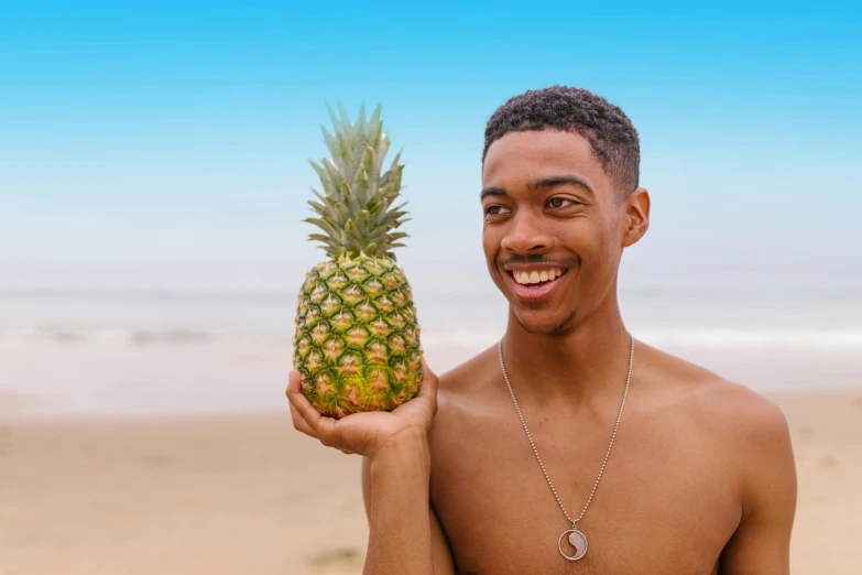 a man holding a pineapple on the beach, pexels contest winner, renaissance, black teenage boy, beefcake pose, smooth blue skin, bowater charlie and brom gerald