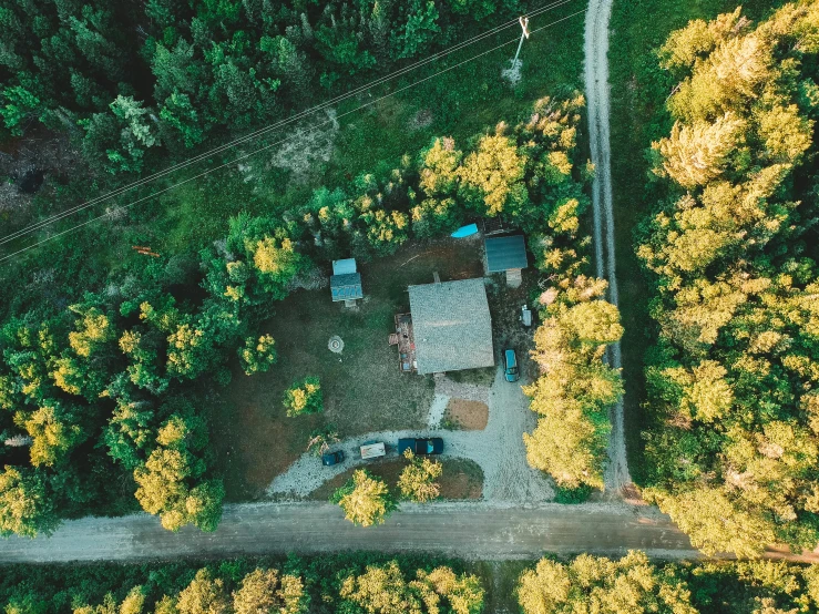 an aerial view of a house in the woods, pexels contest winner, vehicle, camp, low quality photo, golden hour 4k