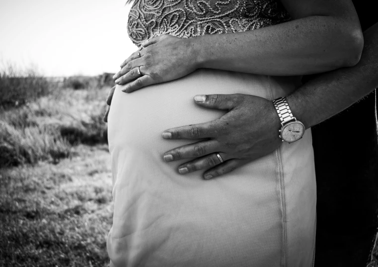 a black and white photo of a pregnant couple, by Kristian Zahrtmann, pexels, hyperdetailed!!, mother, gold, outdoor photo