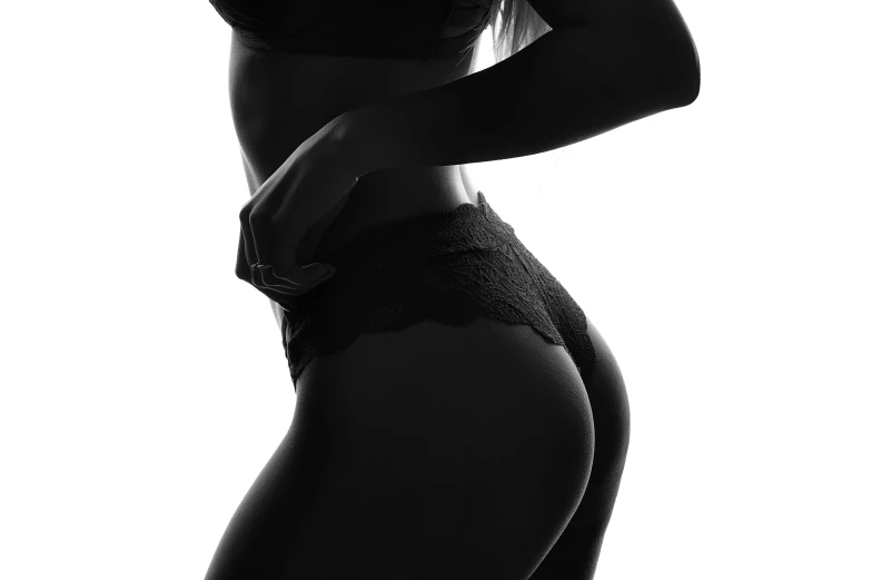 a black and white photo of a woman in lingerie, trending on pexels, black leggings, black silhouette, smooth in _ the background, physical : tinyest midriff ever