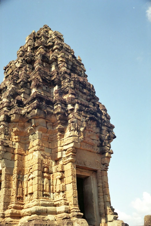 a group of people standing in front of a stone building, at khajuraho, lead - covered spire, vietnam, zoomed out view