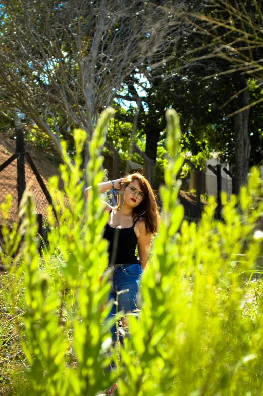 a woman is taking a picture of a giraffe, inspired by Elsa Bleda, happening, garden behind the glasses, 8k 50mm iso 10, lush green, infp young woman