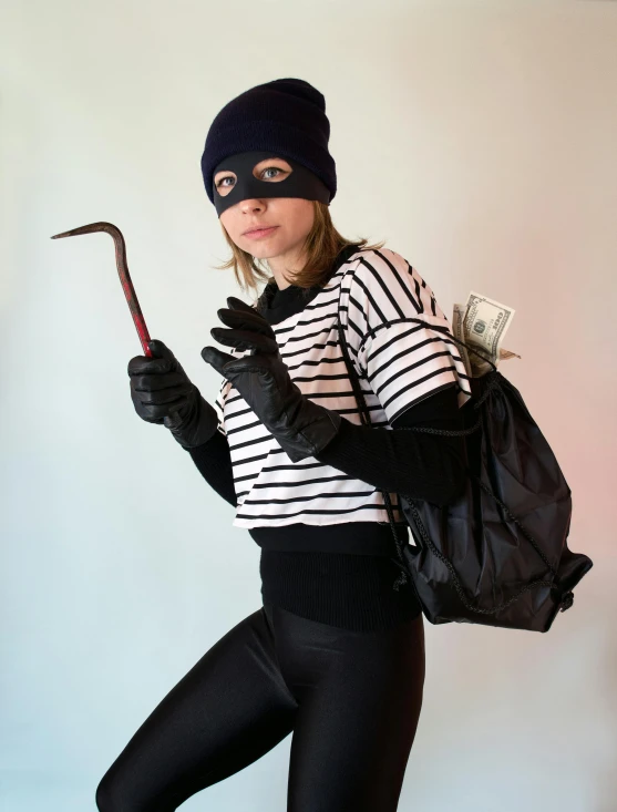 a woman wearing a mask and holding a cane, by Helen Stevenson, trending on pexels, modernism, kevin mitnick as a bank robber, lycra costume, hamburglar, фото девушка курит