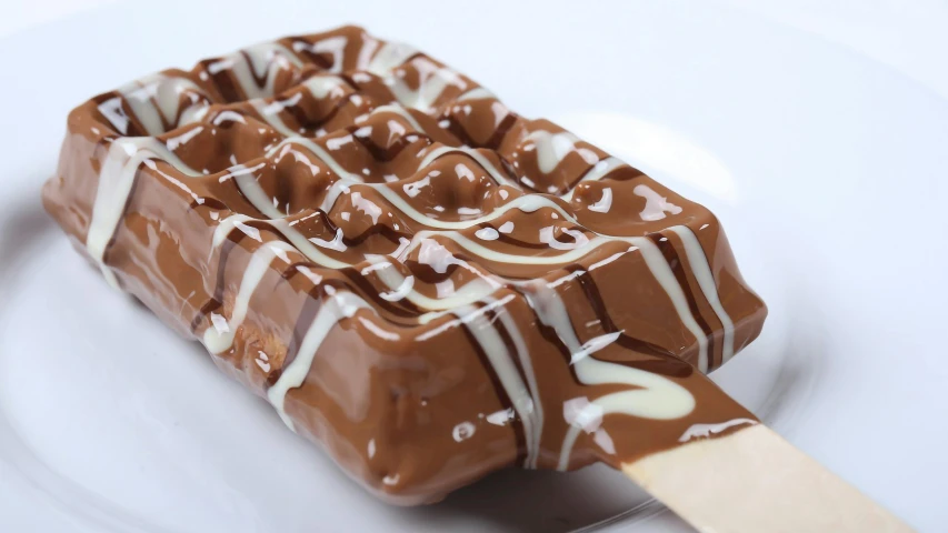 a chocolate ice cream bar sitting on top of a white plate, skewer, glossy and drippy, melbourne, spatula