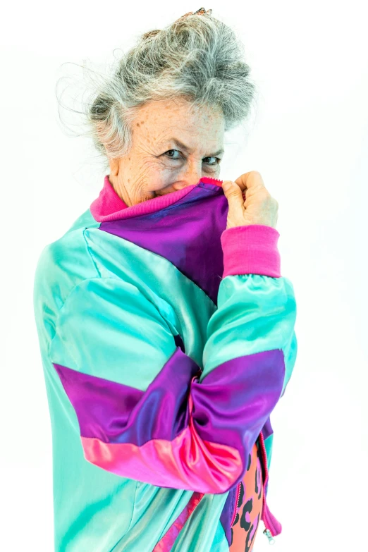 an older woman covers her face with a scarf, an album cover, inspired by Bert Stern, unsplash, wearing a track suit, cyan and magenta, dolman, technicolour 1