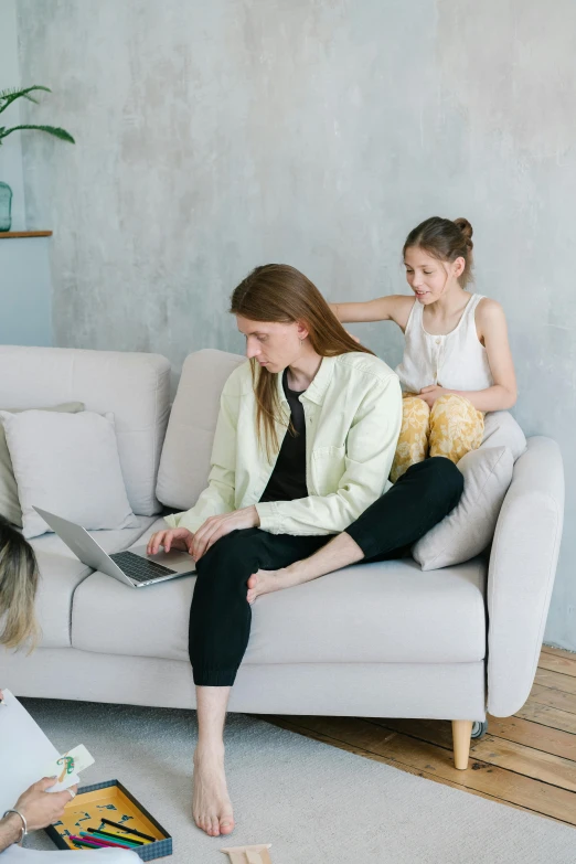 a couple of women sitting on top of a couch, a picture, trending on pexels, with a kid, working, uncomfortable, promotional image