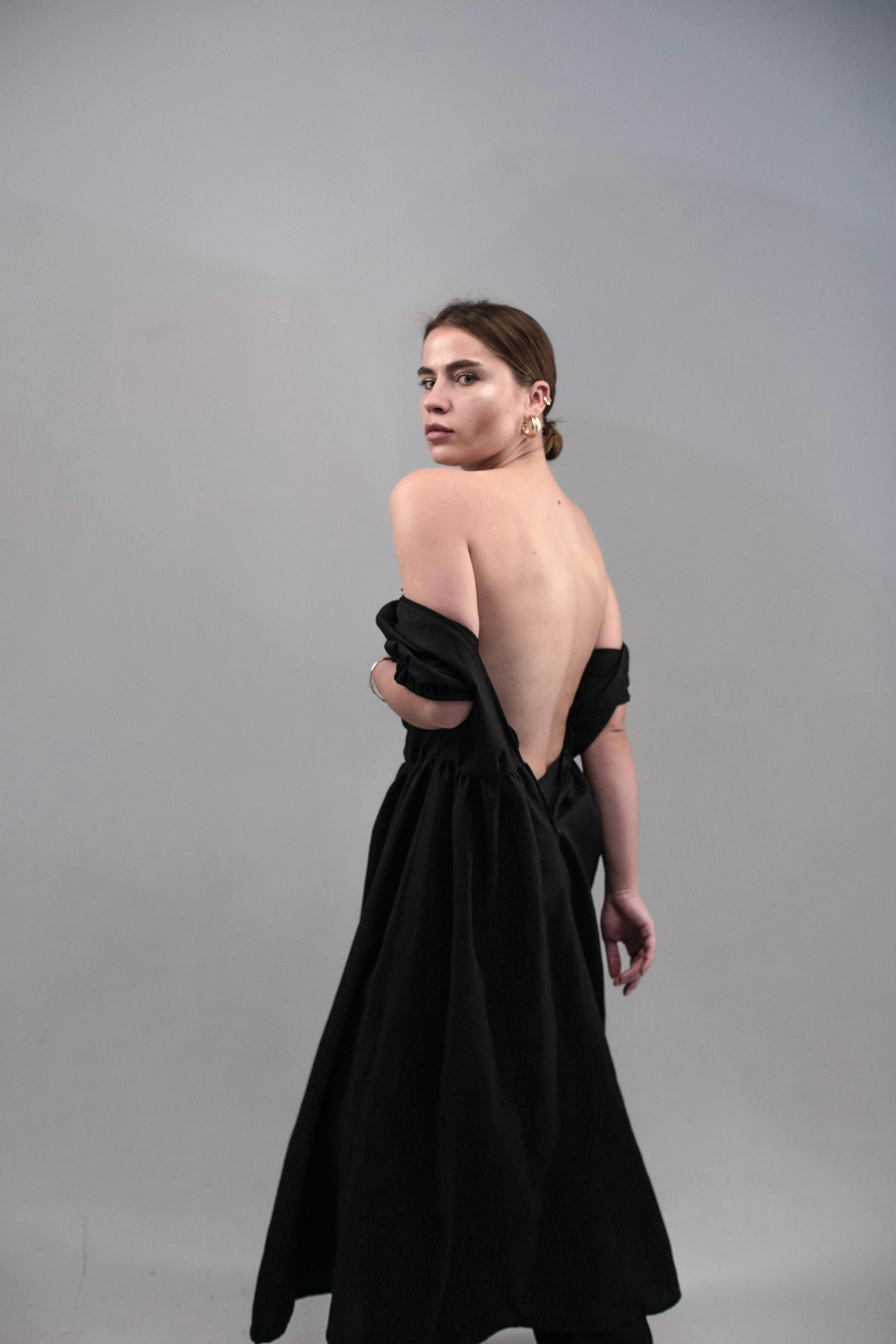 a woman in a black dress posing for a picture, bare back, shot with sony alpha, hila klein, asher duran