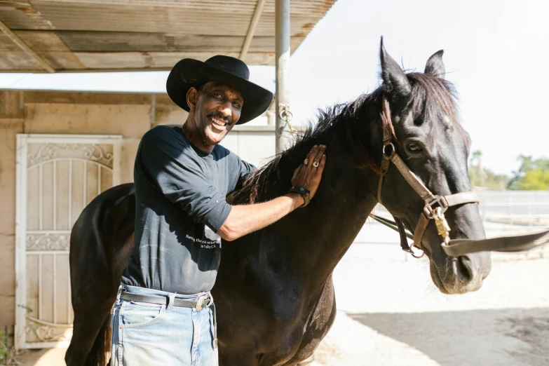 a man that is standing next to a horse, black man, australian, profile image, thumbnail