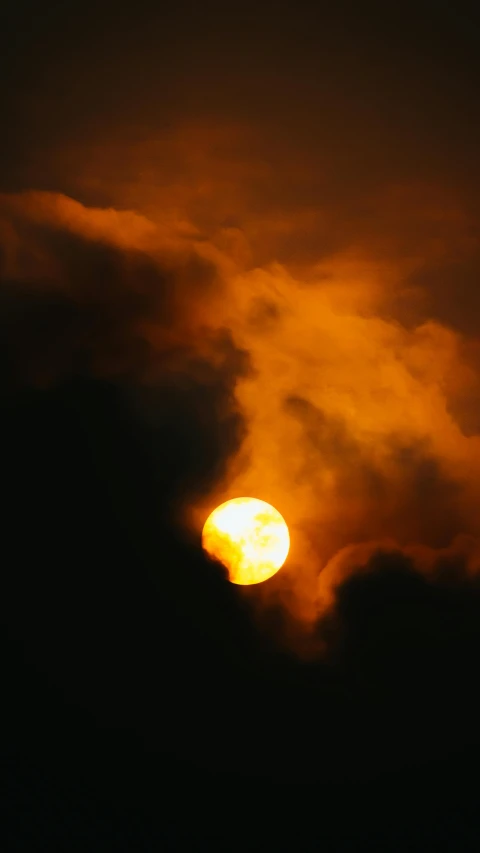 the sun is setting in the dark sky, by Dave Allsop, romanticism, smoke cloud, during an eclipse, yellow, atmospheric ”