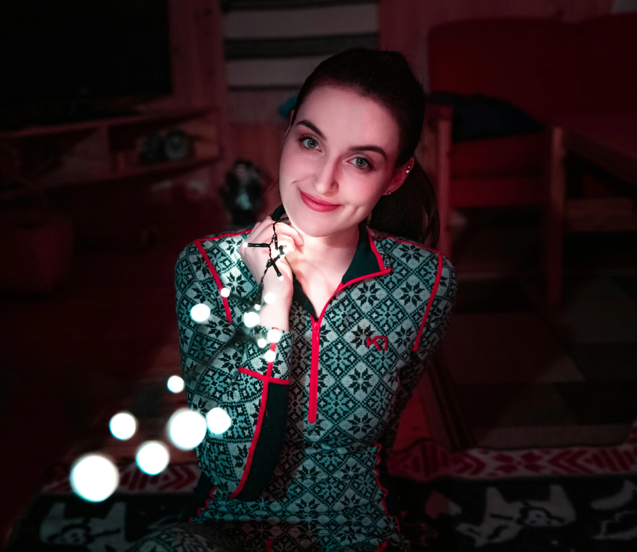 a woman sitting on the floor holding a string of lights, a portrait, by Julia Pishtar, pexels contest winner, wearing pajamas, avatar image, ukrainian girl, pov photo