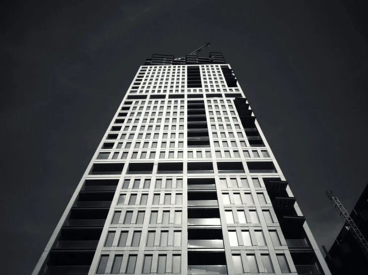 a black and white photo of a tall building, by Mathias Kollros, unsplash, brutalism, taken in the late 2010s, monochrome color, construction, thomas veyrat intricate