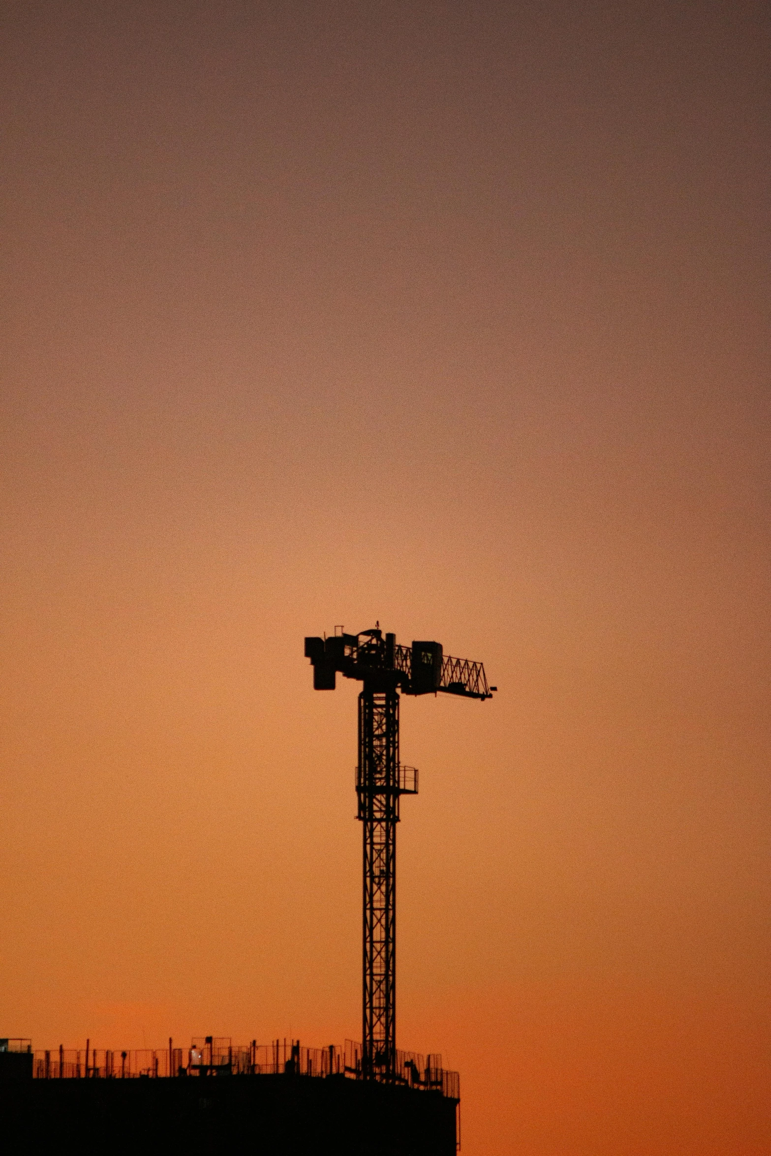 a tall tower sitting in the middle of a sunset, by Paul Bird, minimalism, radio equipment, square, sports photo, ap news photo