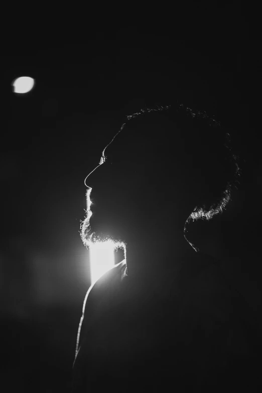 a black and white photo of a person in the dark, a black and white photo, unsplash, light and space, bearded, matthew mcconaughey, silhoutte, post malone