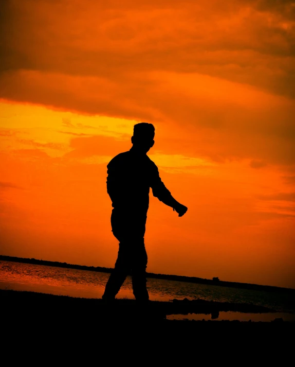 a man walking on the beach at sunset, an album cover, pexels contest winner, romanticism, soldier, lgbt, ((sunset))
