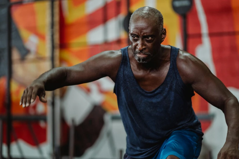 a man in a blue tank top doing squats, a portrait, pexels contest winner, lance reddick, background a gym, action with run and fight, aged 4 0