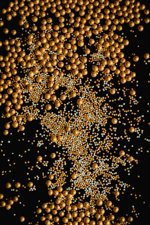 a bunch of gold balls on a black background, by Matt Cavotta, pexels, kinetic pointillism, yeast, swarovski crystals, mustard, 2010s