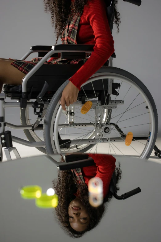 a woman in a wheelchair holding a tennis racquet, an album cover, hyperrealism, reflections on a glass table, b - roll, robotics, ameera al-taweel