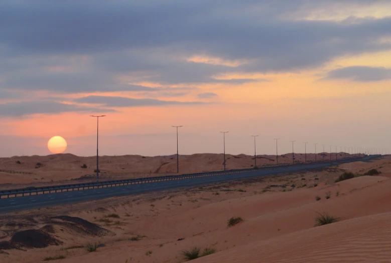 a long road in the middle of a desert, pexels contest winner, hurufiyya, street moon landscape, tanned ameera al taweel, sunset panorama, pastel hues