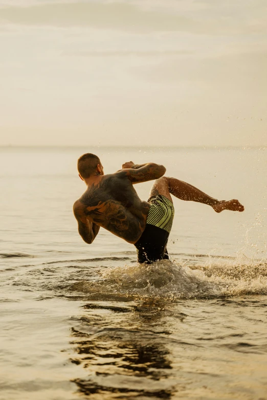 a man riding a surfboard on top of a body of water, kickboxing, in the evening, tattooed, camaraderie