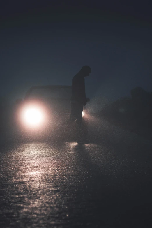 a person walking in the rain in front of a car, pexels contest winner, foggy twilight lighting, sad man, battered, standing in moonlight